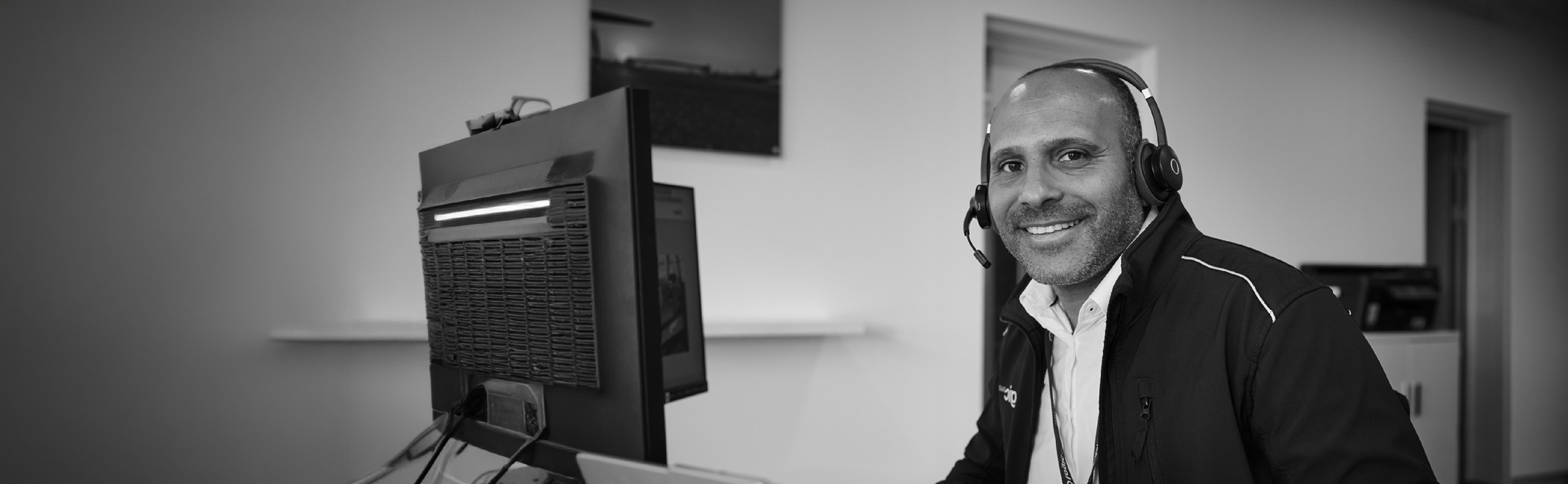 A Logic 360 colleague at a desk wearing a headset